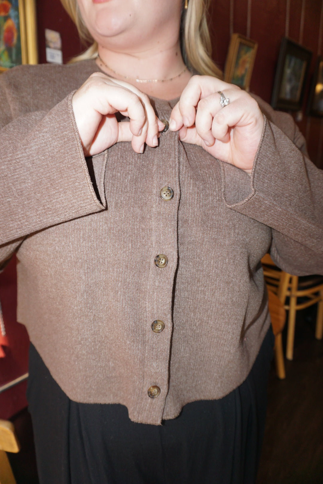 A luxurious ribbed material cardigan, in a lovely chocolate brown color, with a button down front.