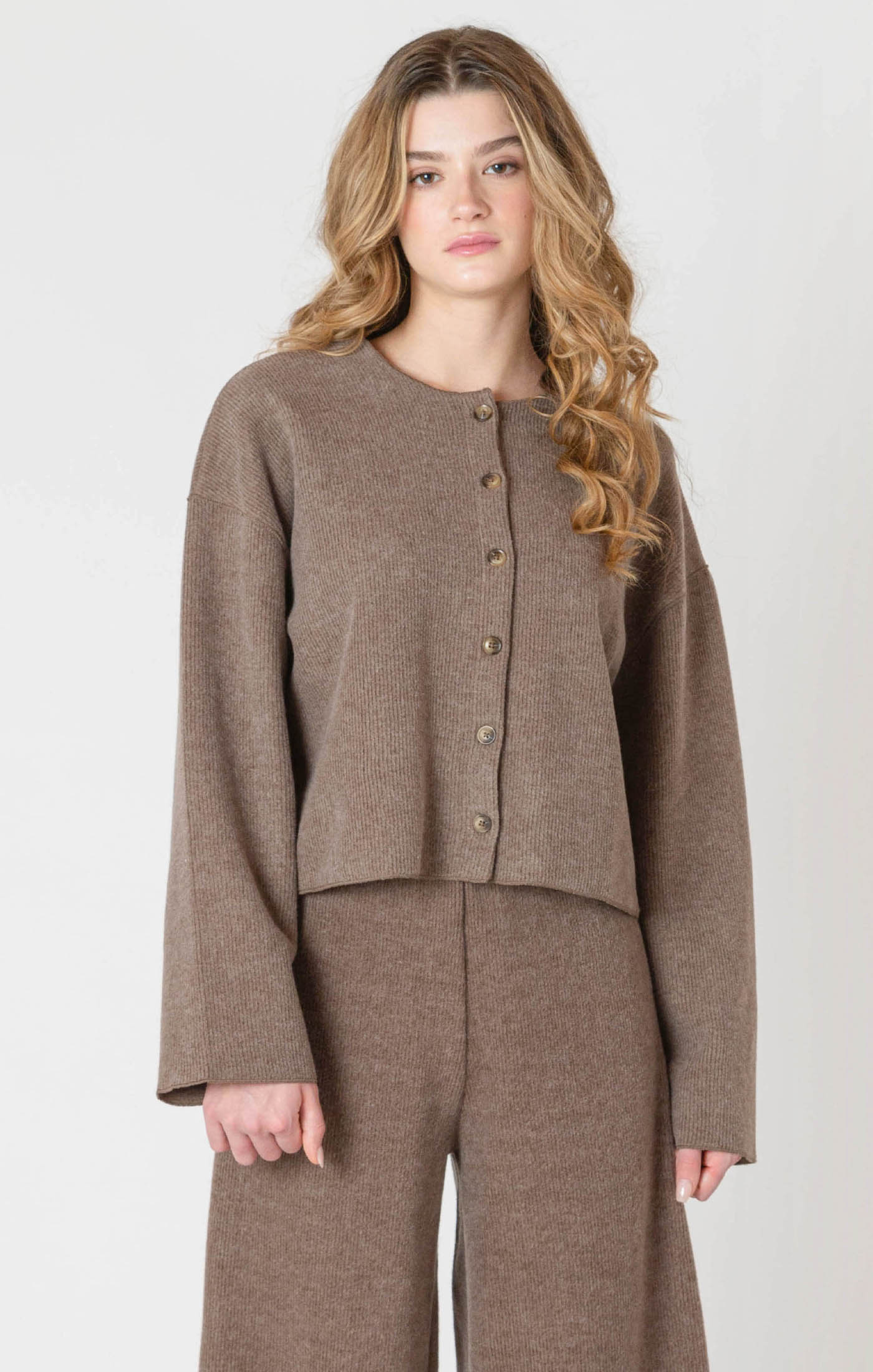 A luxurious ribbed material cardigan, in a lovely chocolate brown color, with a button down front.