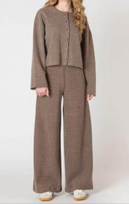 A luxurious ribbed material cardigan, in a lovely chocolate brown color, with a button down front.