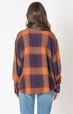 A flannel style button up shirt, with orange, blue, and red autumnal colors. 