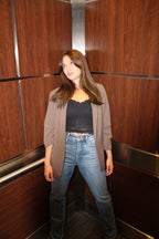 An ash brown blazer with scrunched sleeve detail and open front.