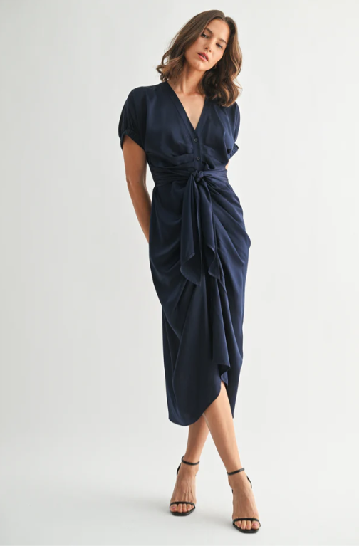 Woman wearing a navy blue dress on a white background