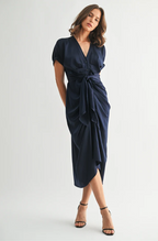 Woman wearing a navy blue dress on a white background