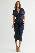 Woman wearing a navy blue dress on a white background