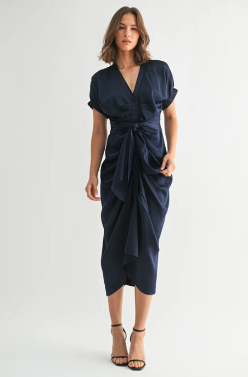 Woman wearing a navy blue dress on a white background