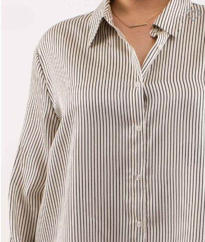 Close-up of a person wearing a striped shirt with a plain background
