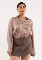 Woman wearing a brown striped shirt and skirt on a white background