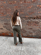 Super cute sage green denim material pants, with wide legs and a tall hem.