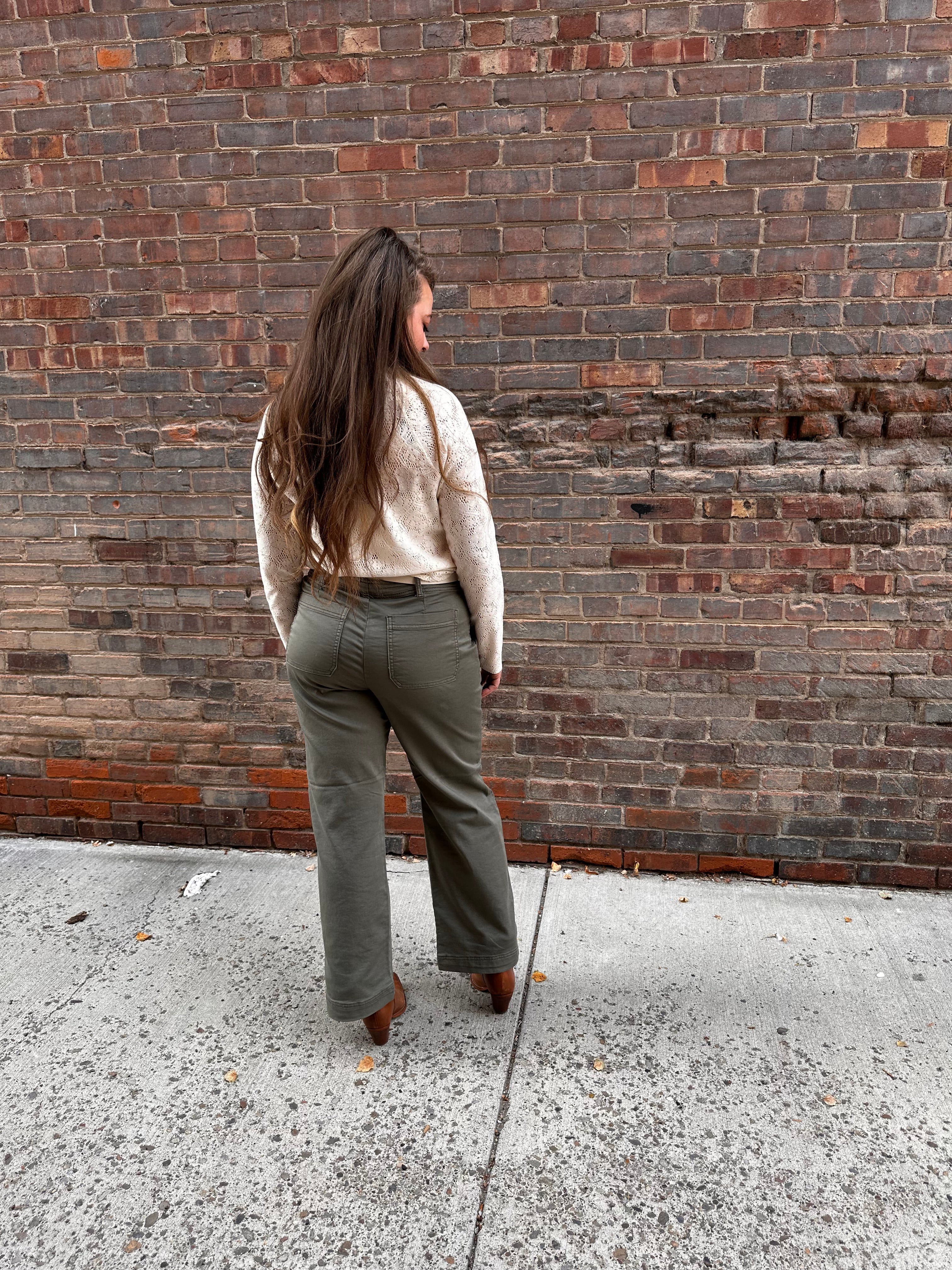 Super cute sage green denim material pants, with wide legs and a tall hem.