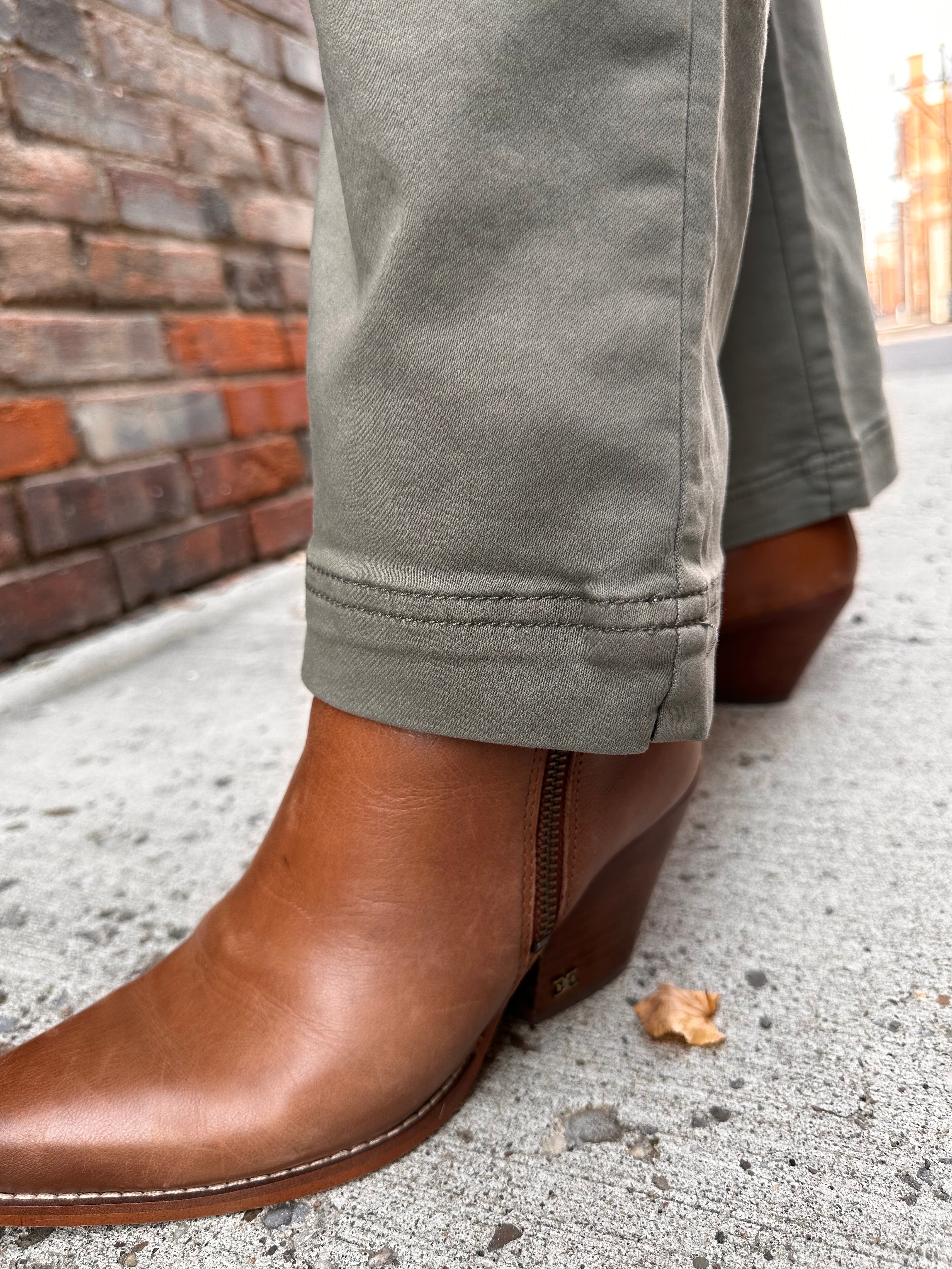 Super cute sage green denim material pants, with wide legs and a tall hem.