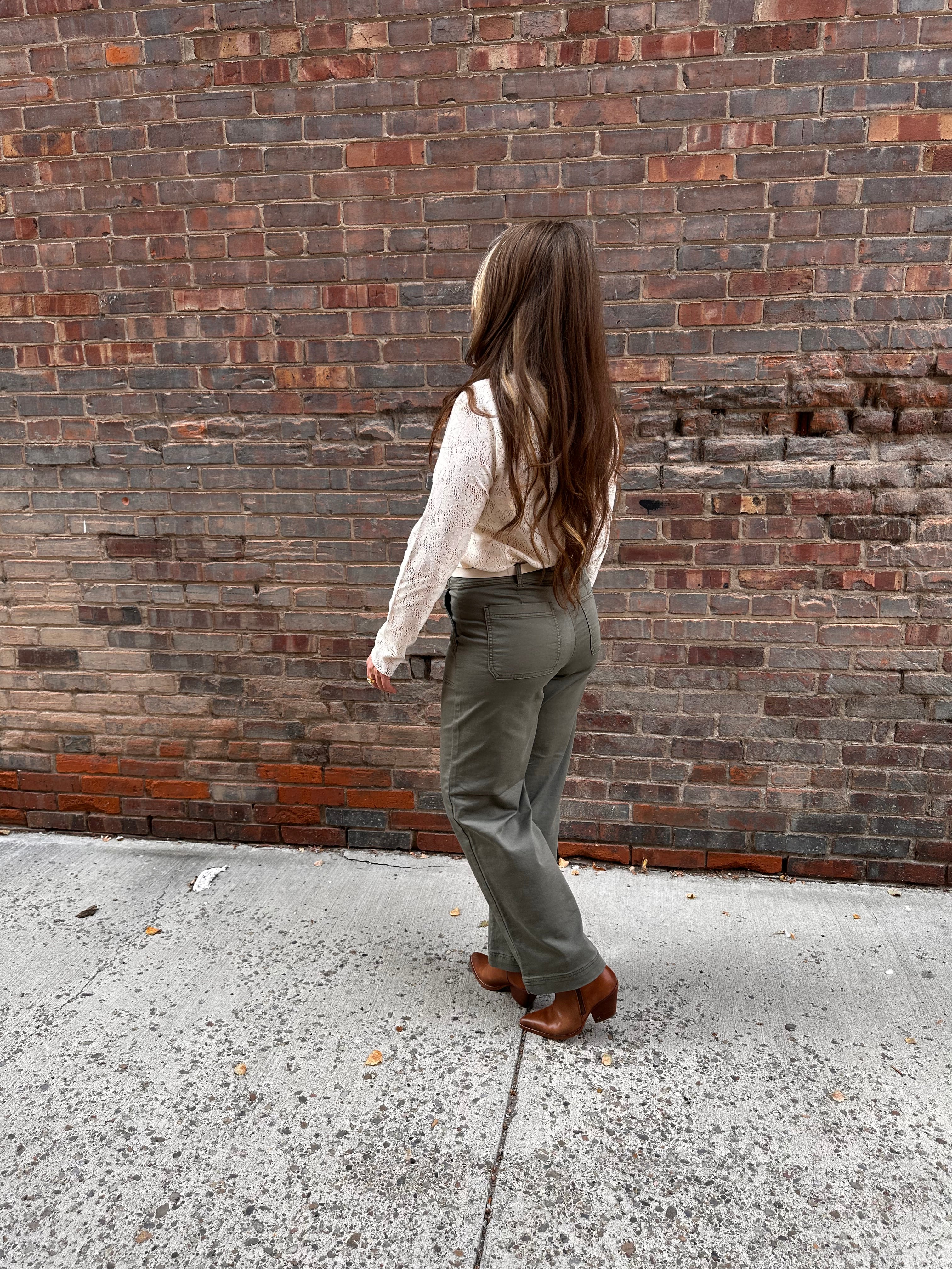 Super cute sage green denim material pants, with wide legs and a tall hem.
