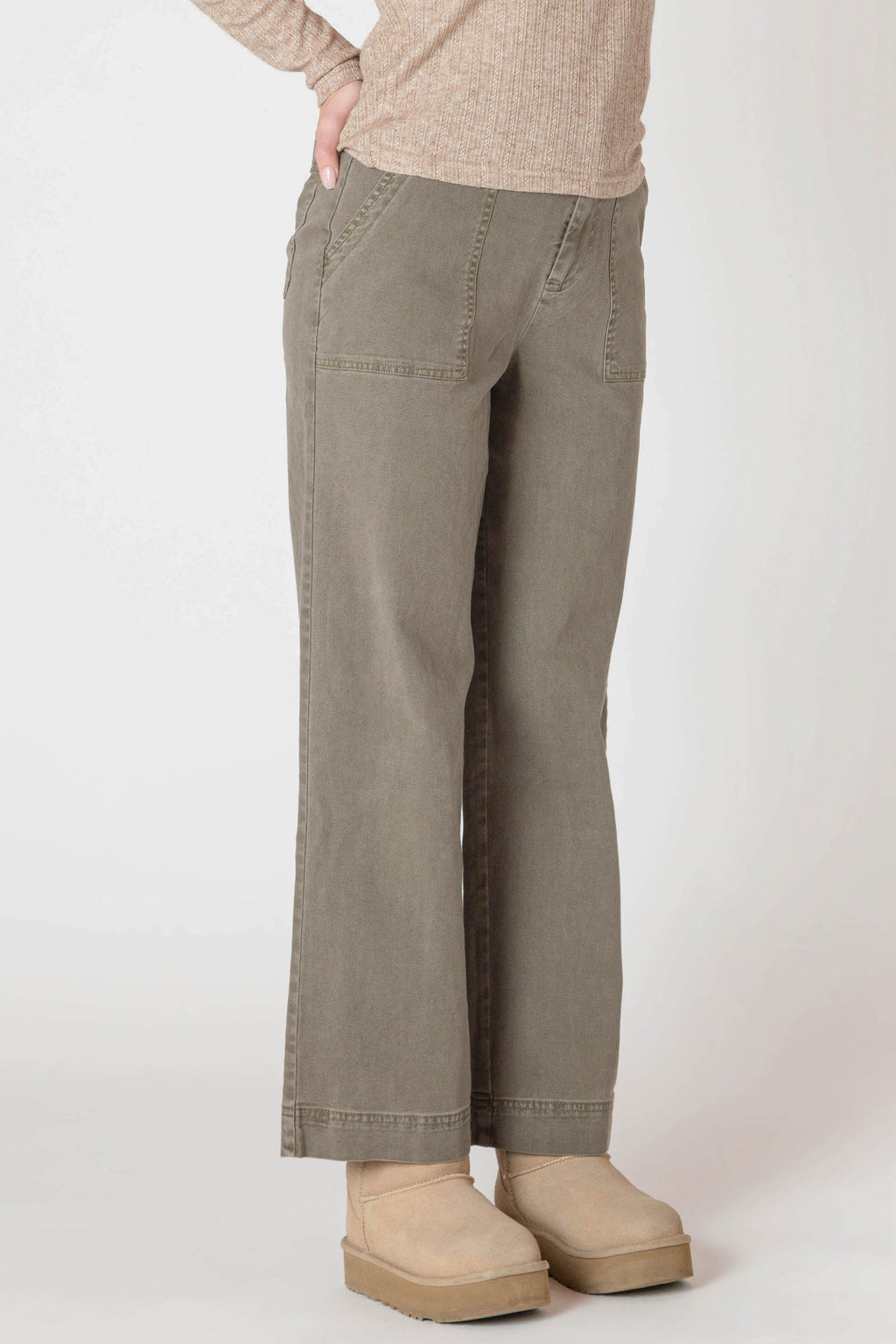 Super cute sage green denim material pants, with wide legs and a tall hem.