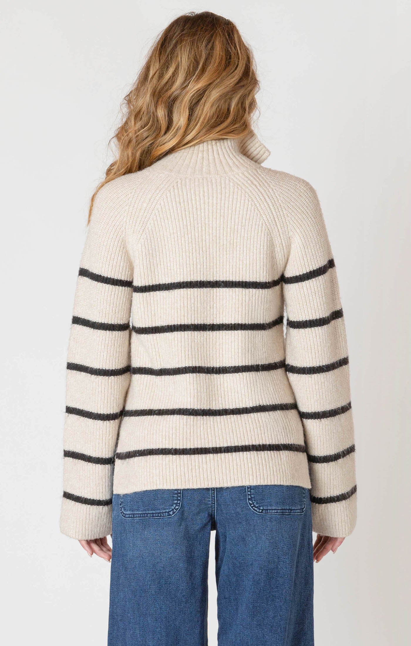 A cozy cream sweater with horizontal black stripes, and a half zipper, and a collar.