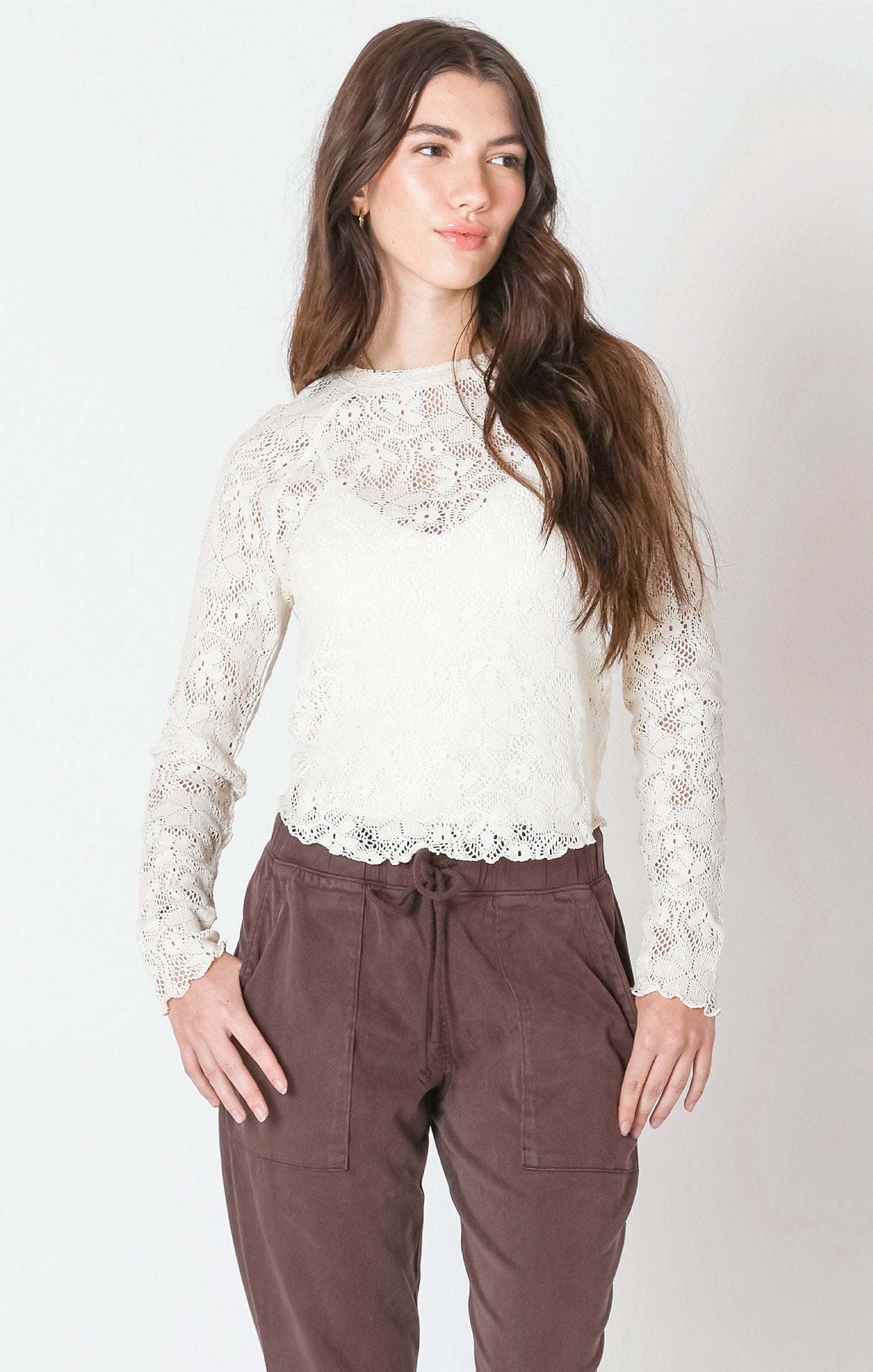 A long sleeve cream shirt with a lace pattern.