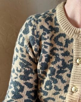 Close-up of a patterned sweater with a neutral background