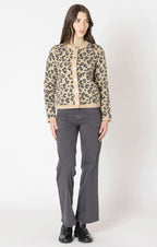 A tan cardigan with grey/black leopard print detail, with a button down front. 