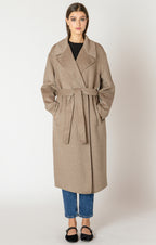 A beautiful and timeless oat colored coat, with a tie waste, a trench like lapel, and pockets.