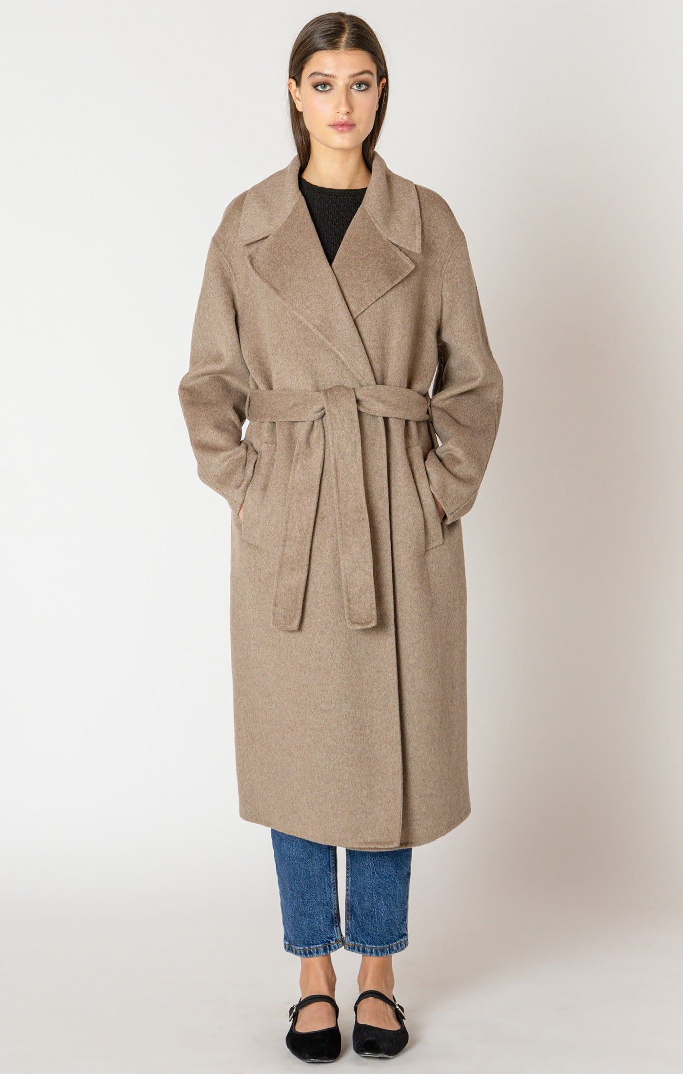 A beautiful and timeless oat colored coat, with a tie waste, a trench like lapel, and pockets.