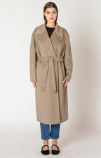 A beautiful and timeless oat colored coat, with a tie waste, a trench like lapel, and pockets.