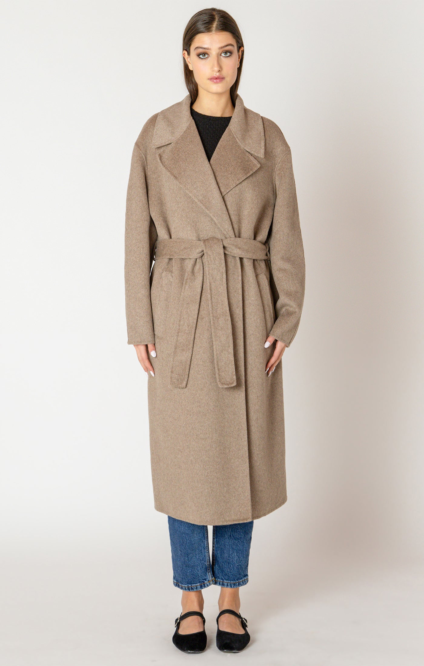 A beautiful and timeless oat colored coat, with a tie waste, a trench like lapel, and pockets.