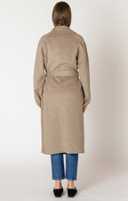 A beautiful and timeless oat colored coat, with a tie waste, a trench like lapel, and pockets.