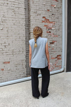 A grey vest with lightly padded shoulders, and two vents in the back.