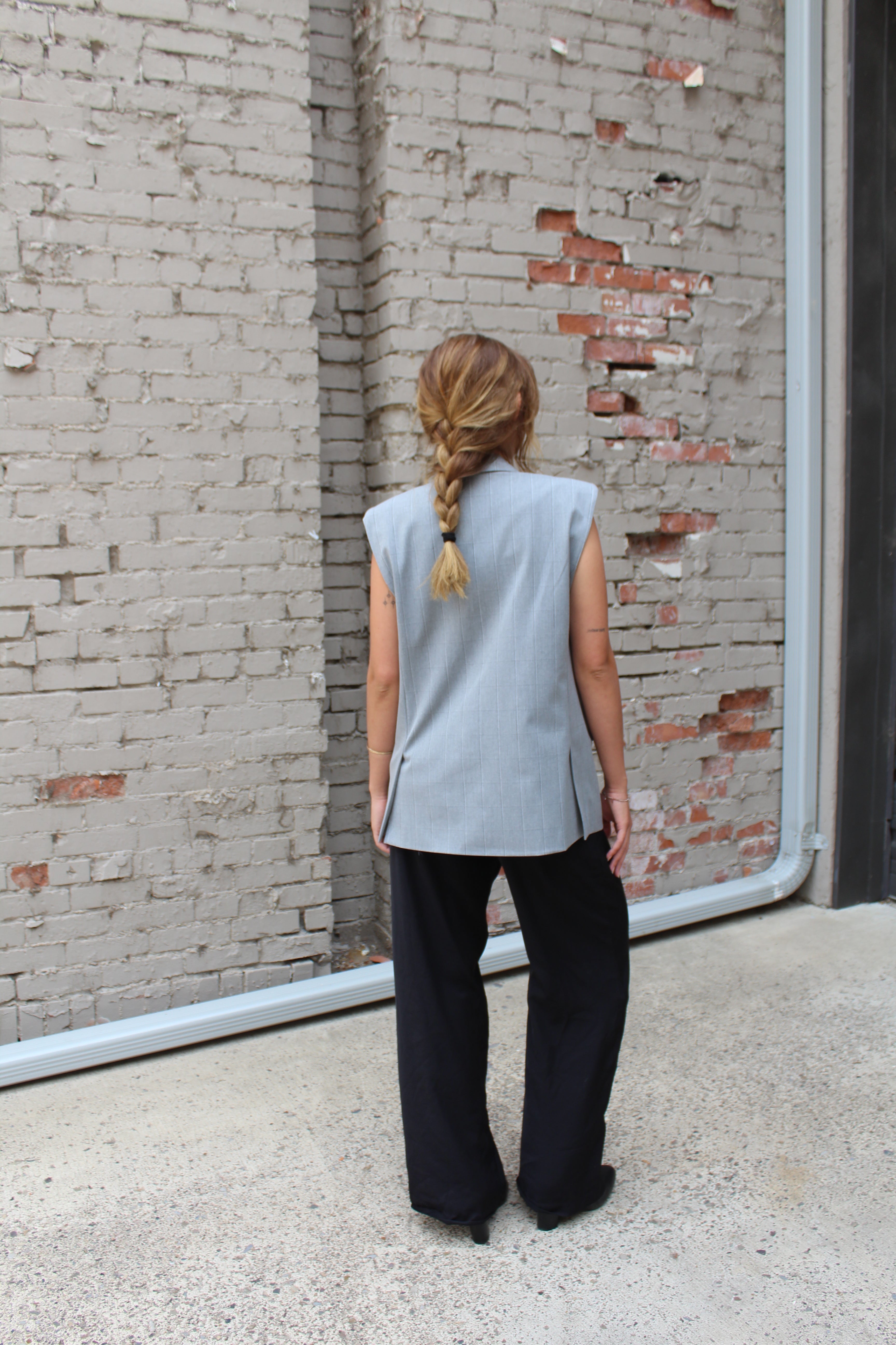 A grey vest with lightly padded shoulders, and two vents in the back.