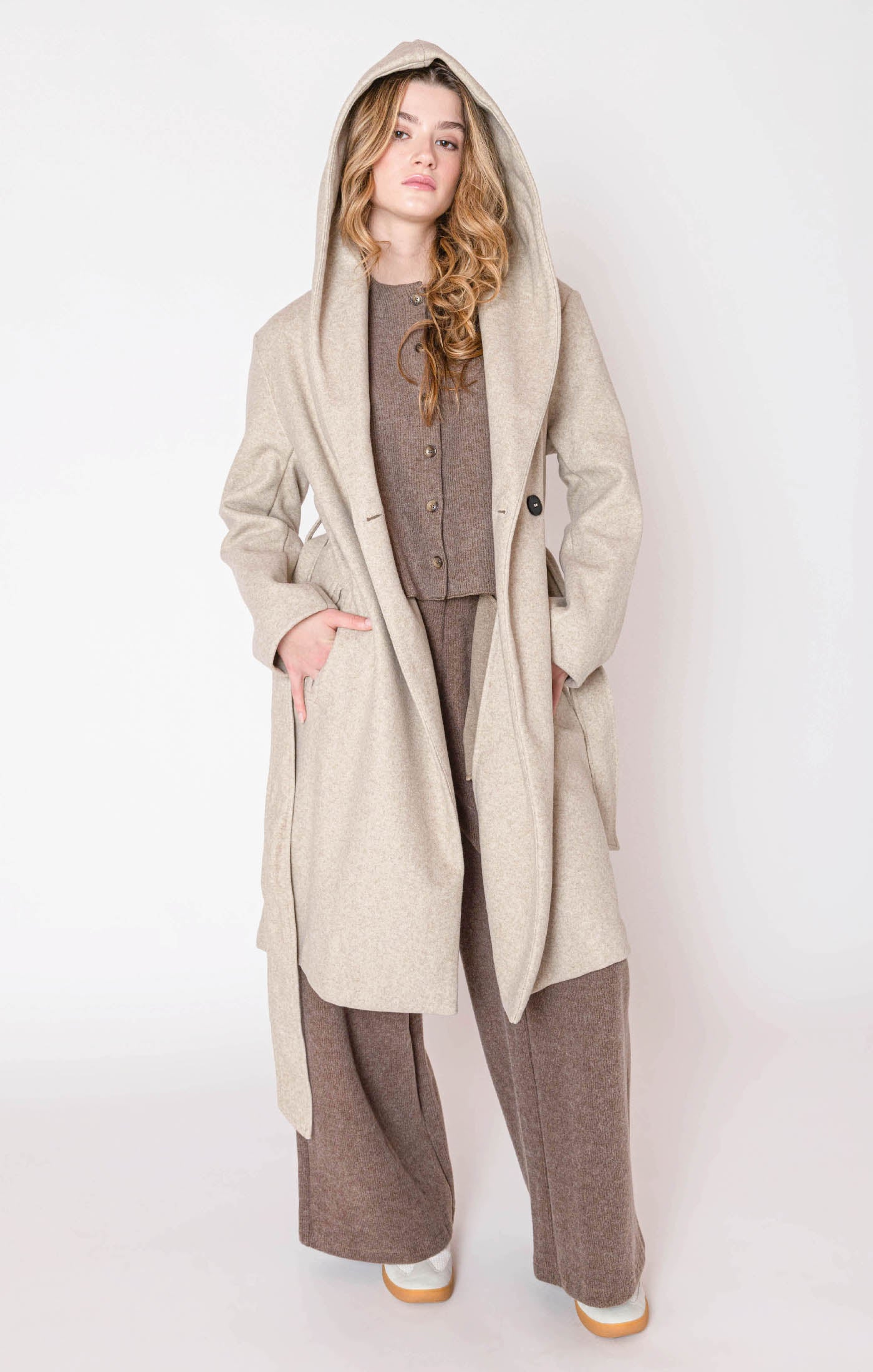 Oatmeal colored hooded trench coat jacket with a tie waist, and button front.