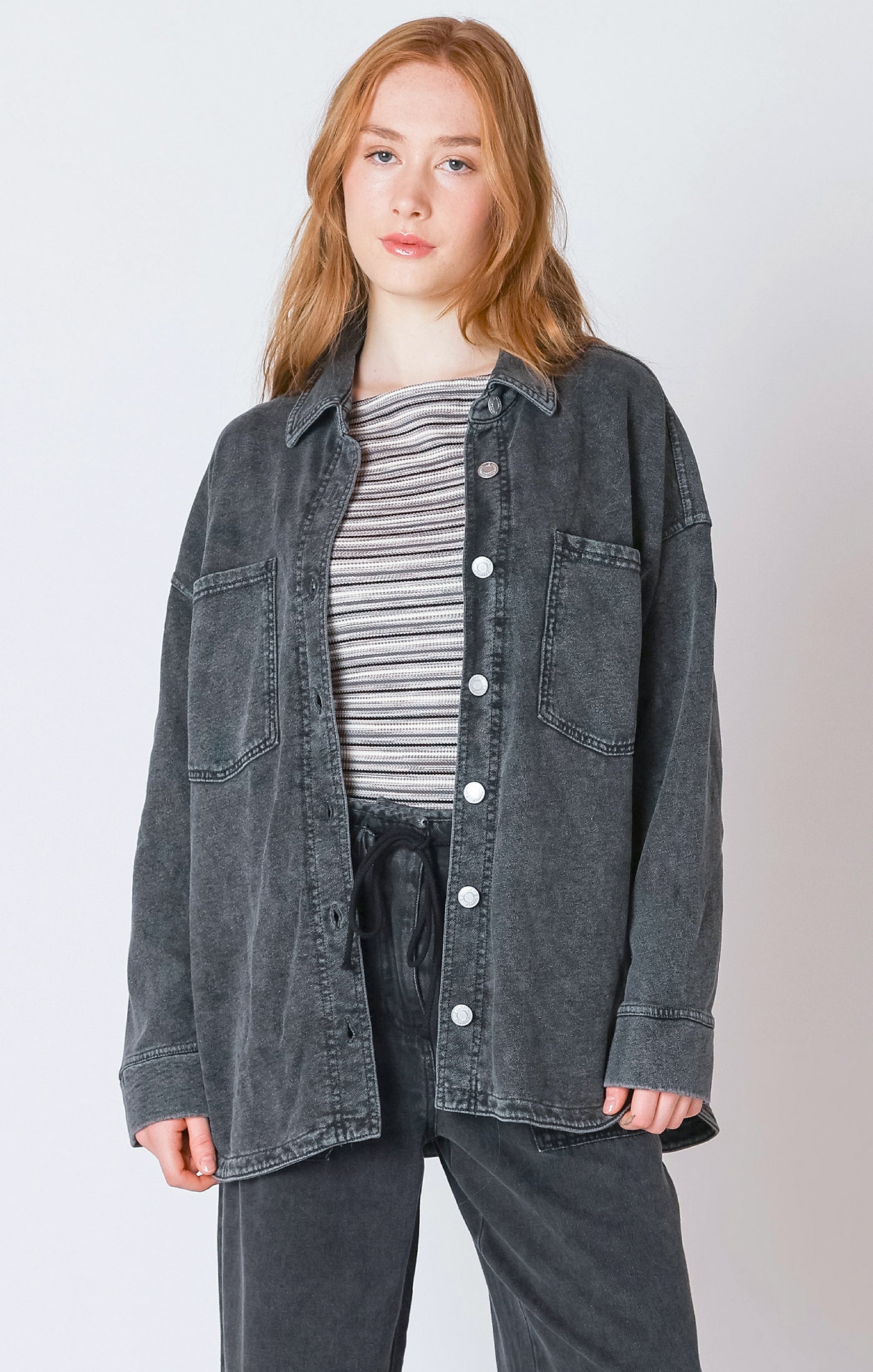 A charcoal button down light-weight jacket, that is perfect for the fall weather.