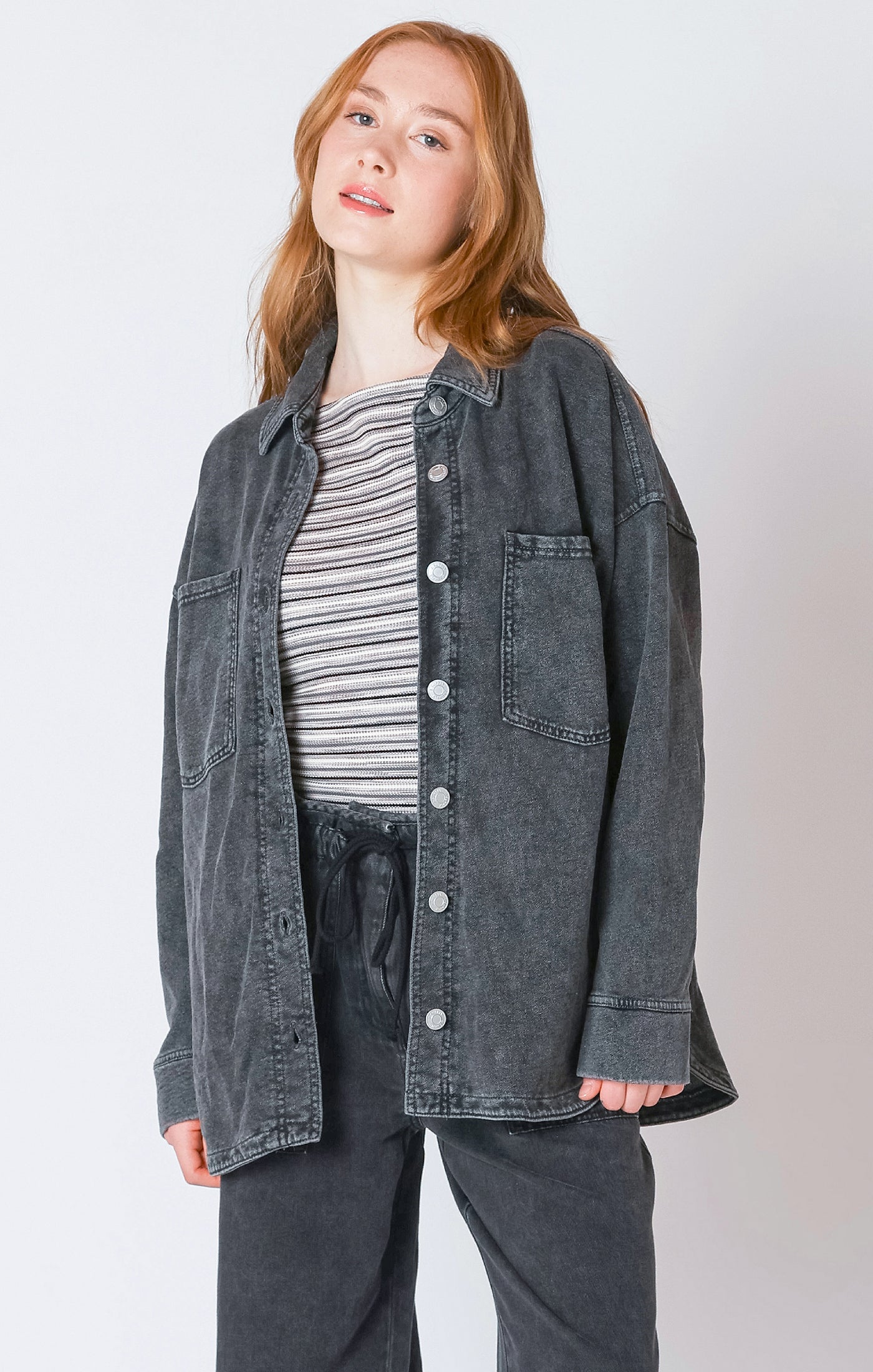 A charcoal button down light-weight jacket, that is perfect for the fall weather.