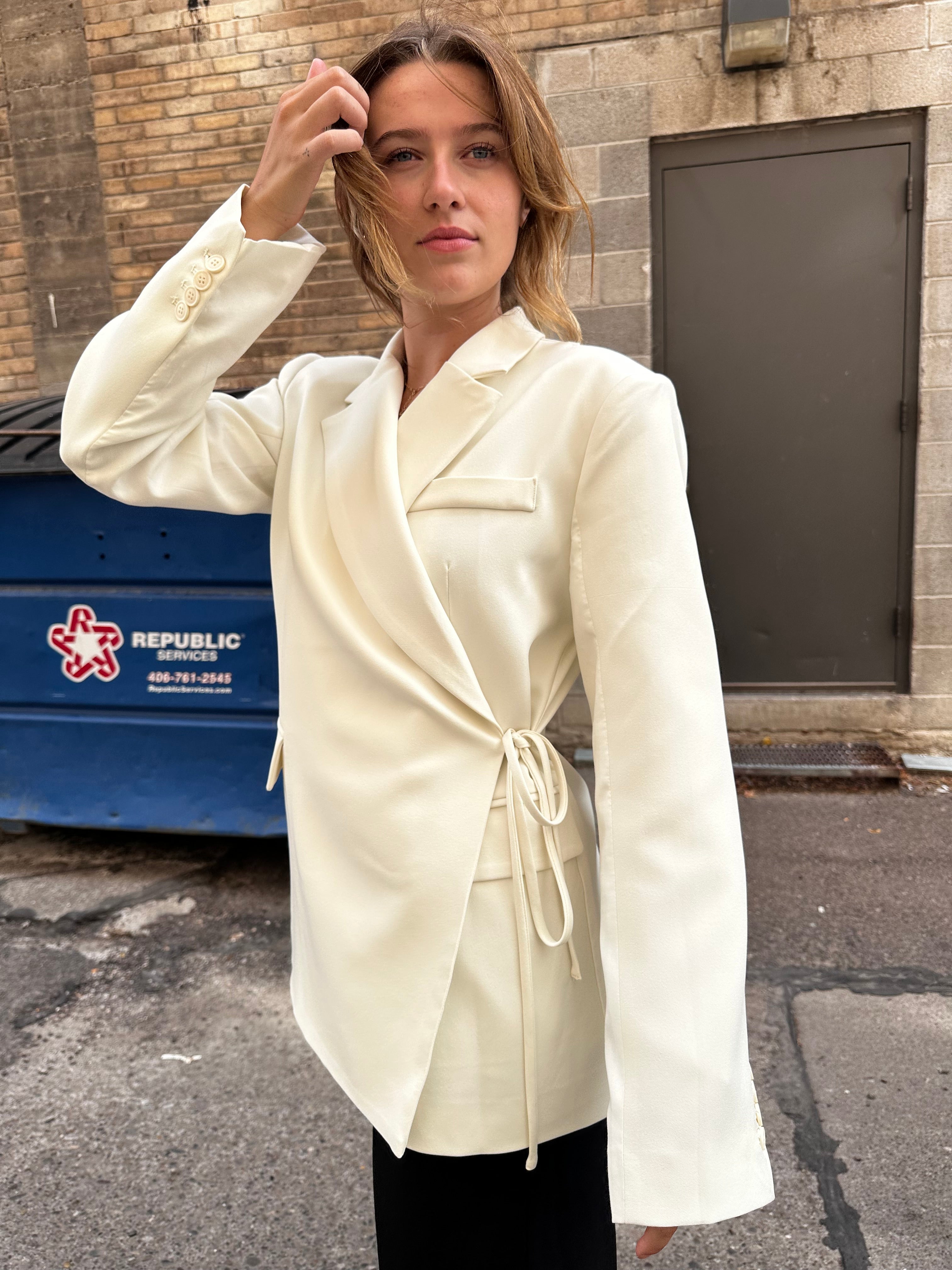 A sharp white blazer with a side tie detail.