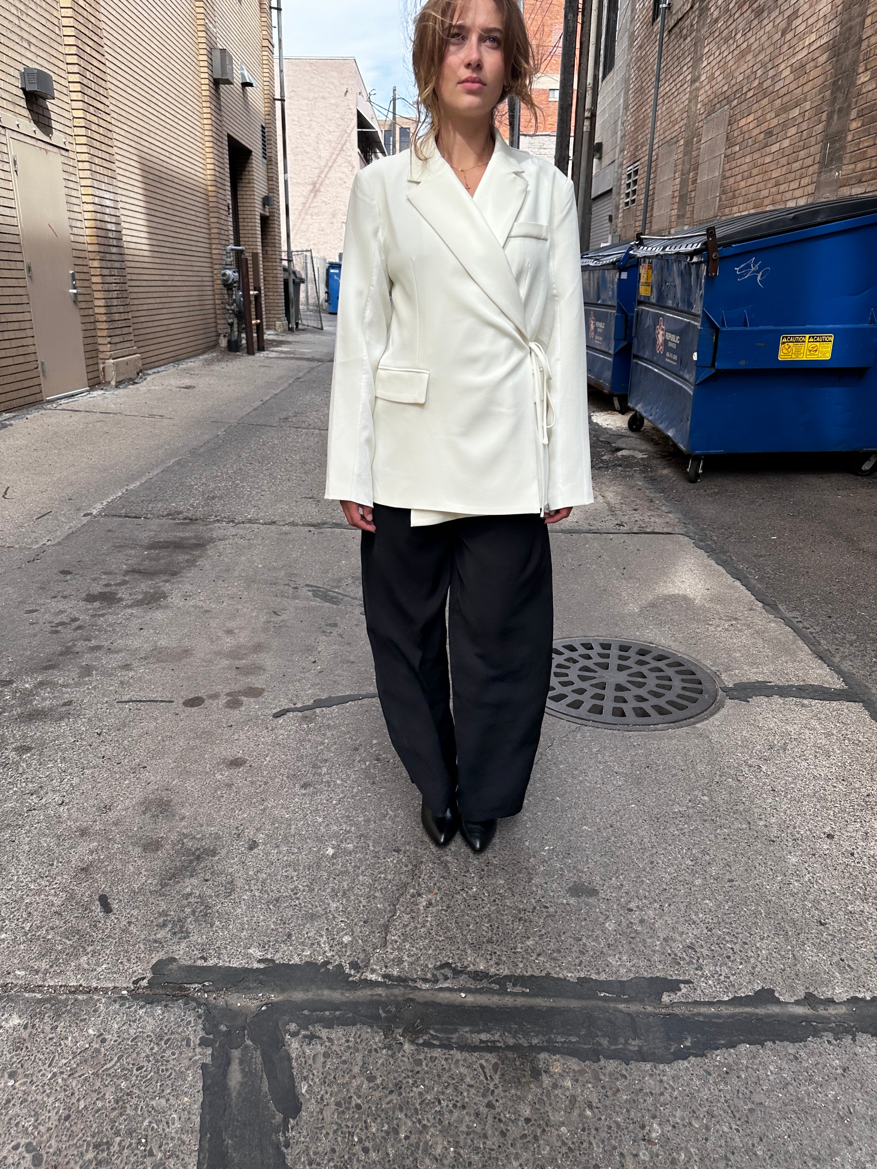 A sharp white blazer with a side tie detail.
