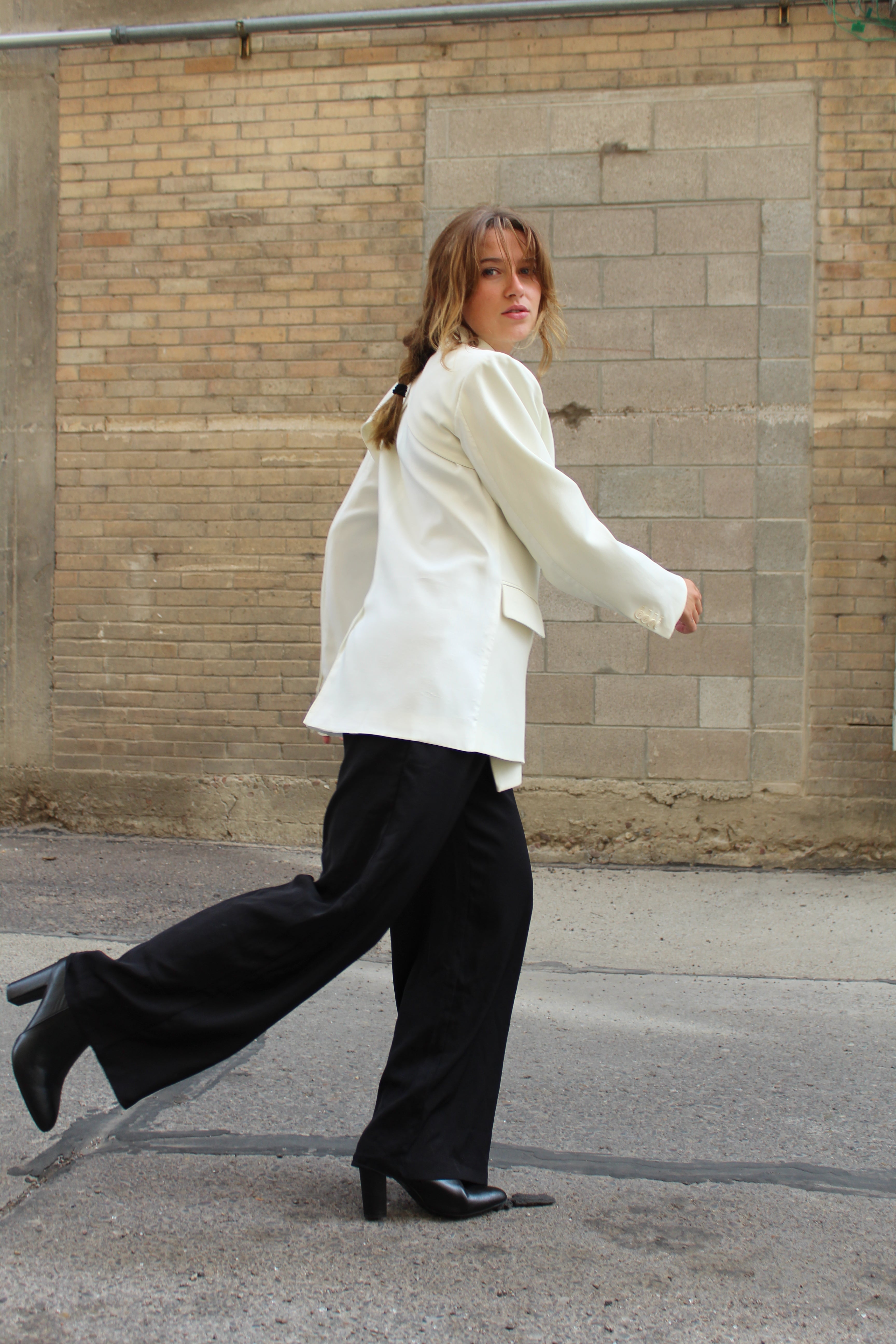 A white suite jacket with a side tie detail.