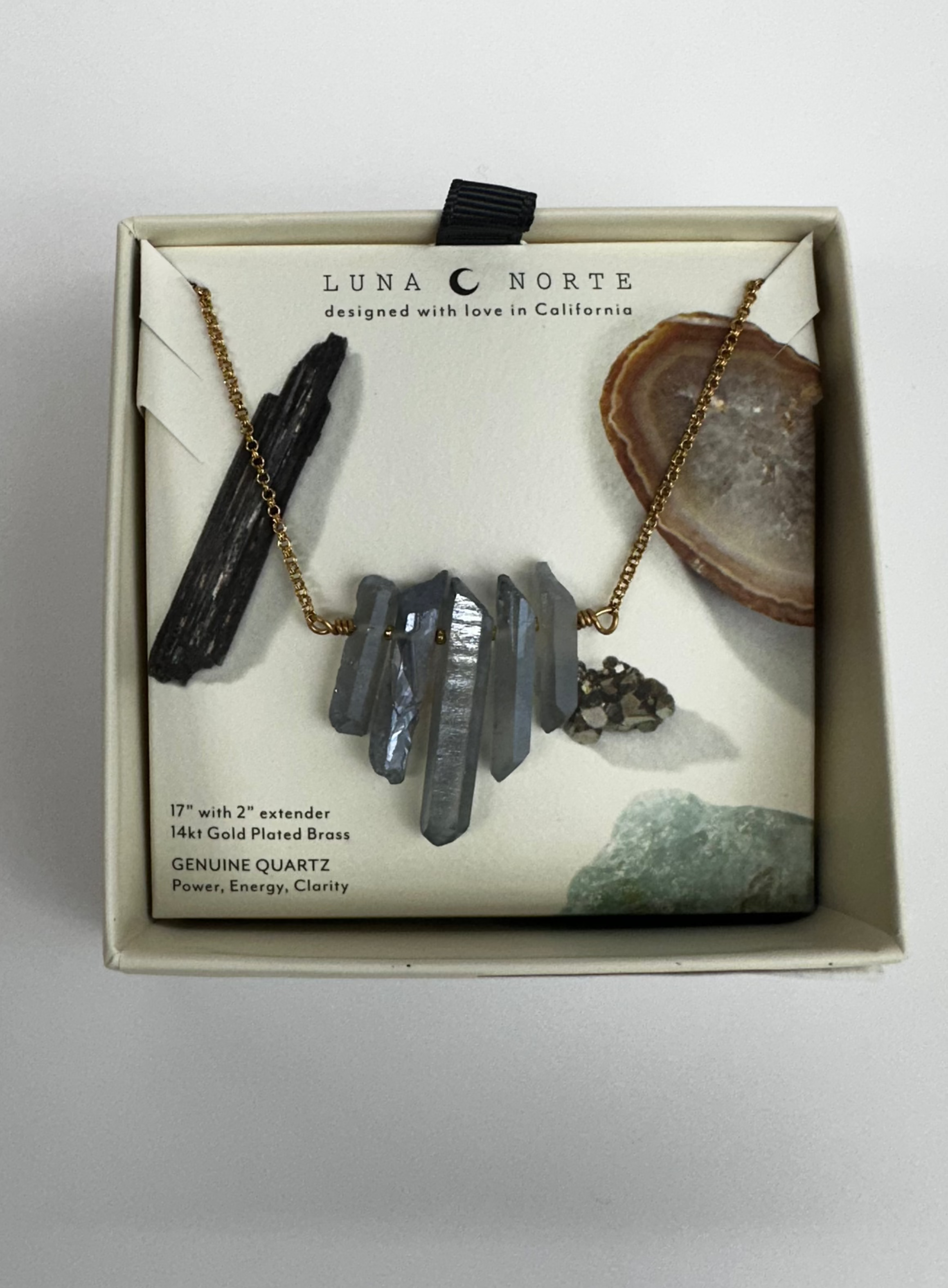 Blue stone pendants on a dainty gold chain, in the Luna Norte box