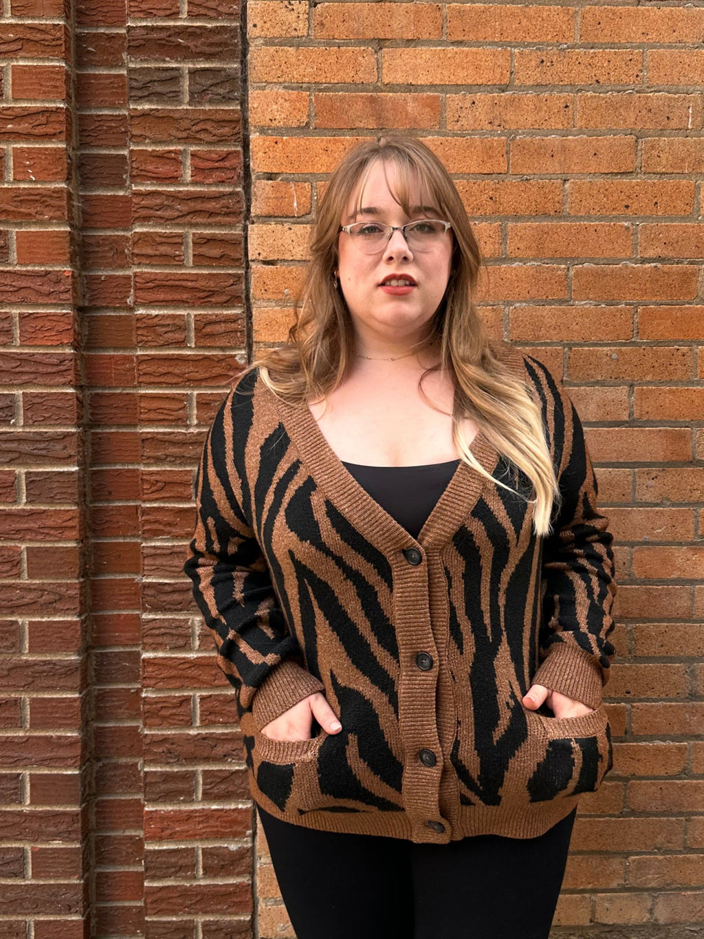 A luxuriously soft brown cardigan, with black animal print striping, pockets, and a button down front.