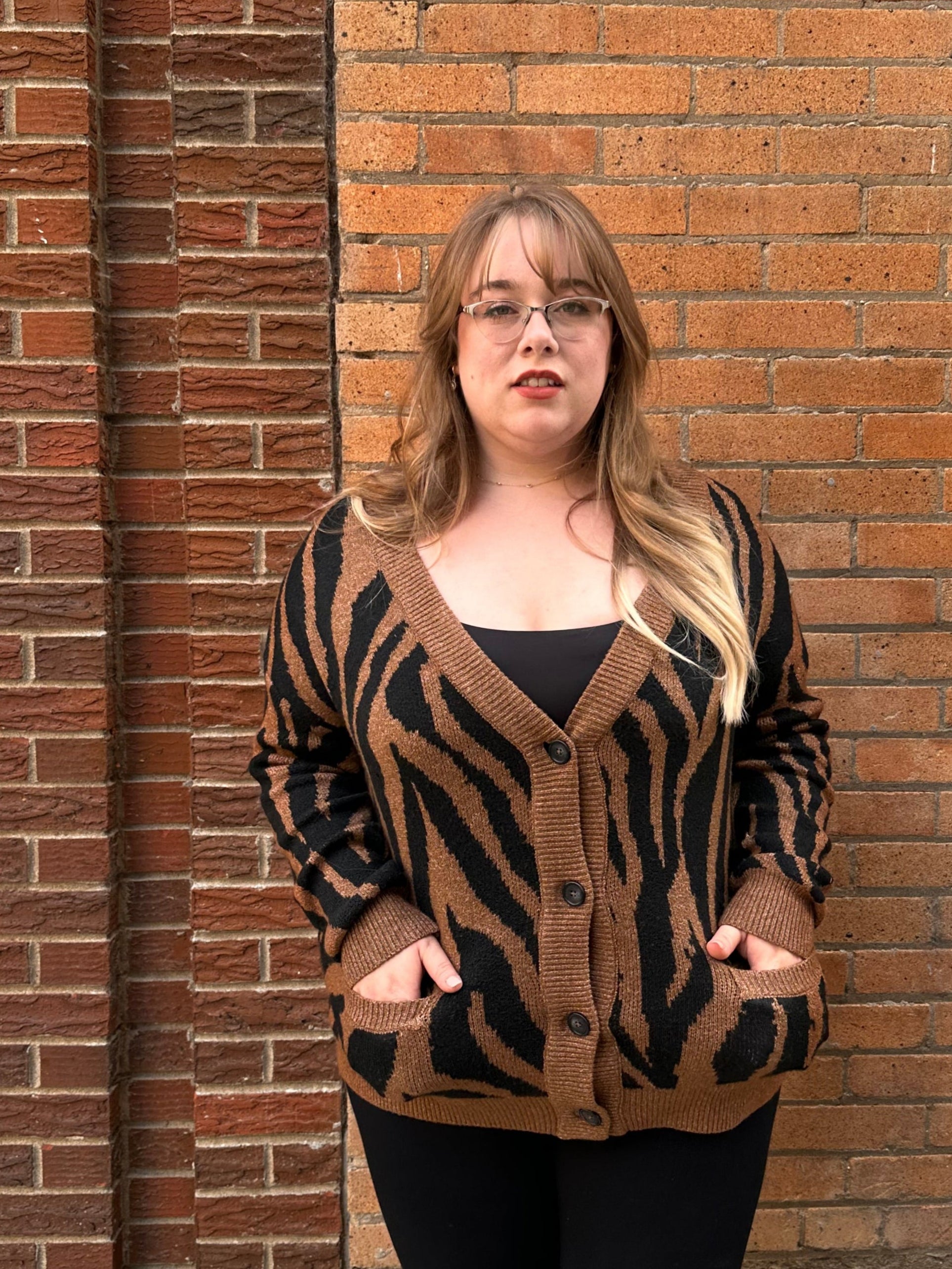 A luxuriously soft brown cardigan, with black animal print striping, pockets, and a button down front.