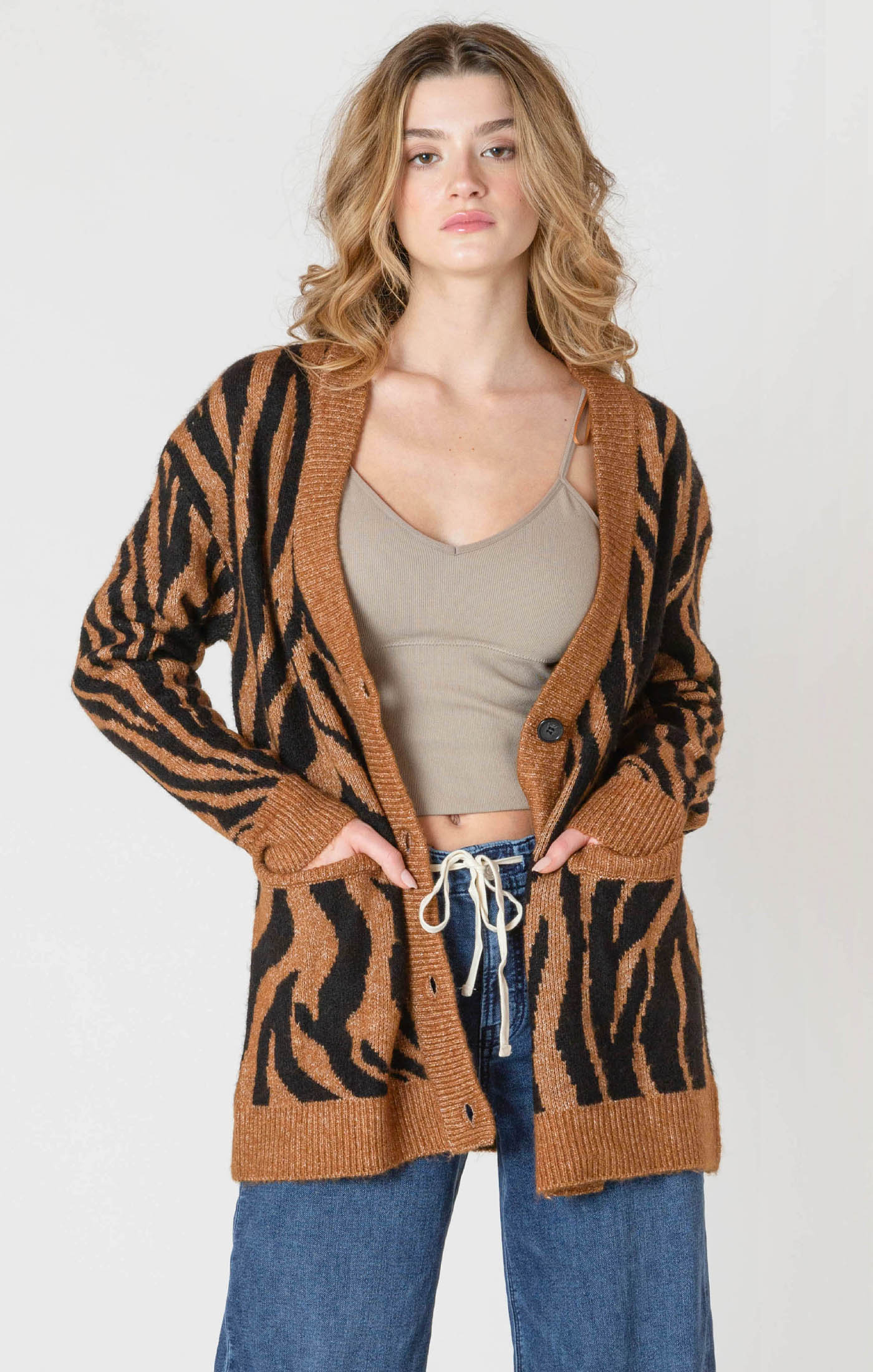 A luxuriously soft brown cardigan, with black animal print striping, pockets, and a button down front.