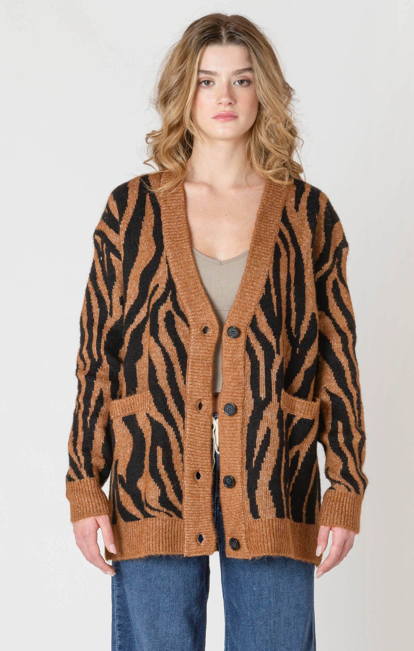 A luxuriously soft brown cardigan, with black animal print striping, pockets, and a button down front.
