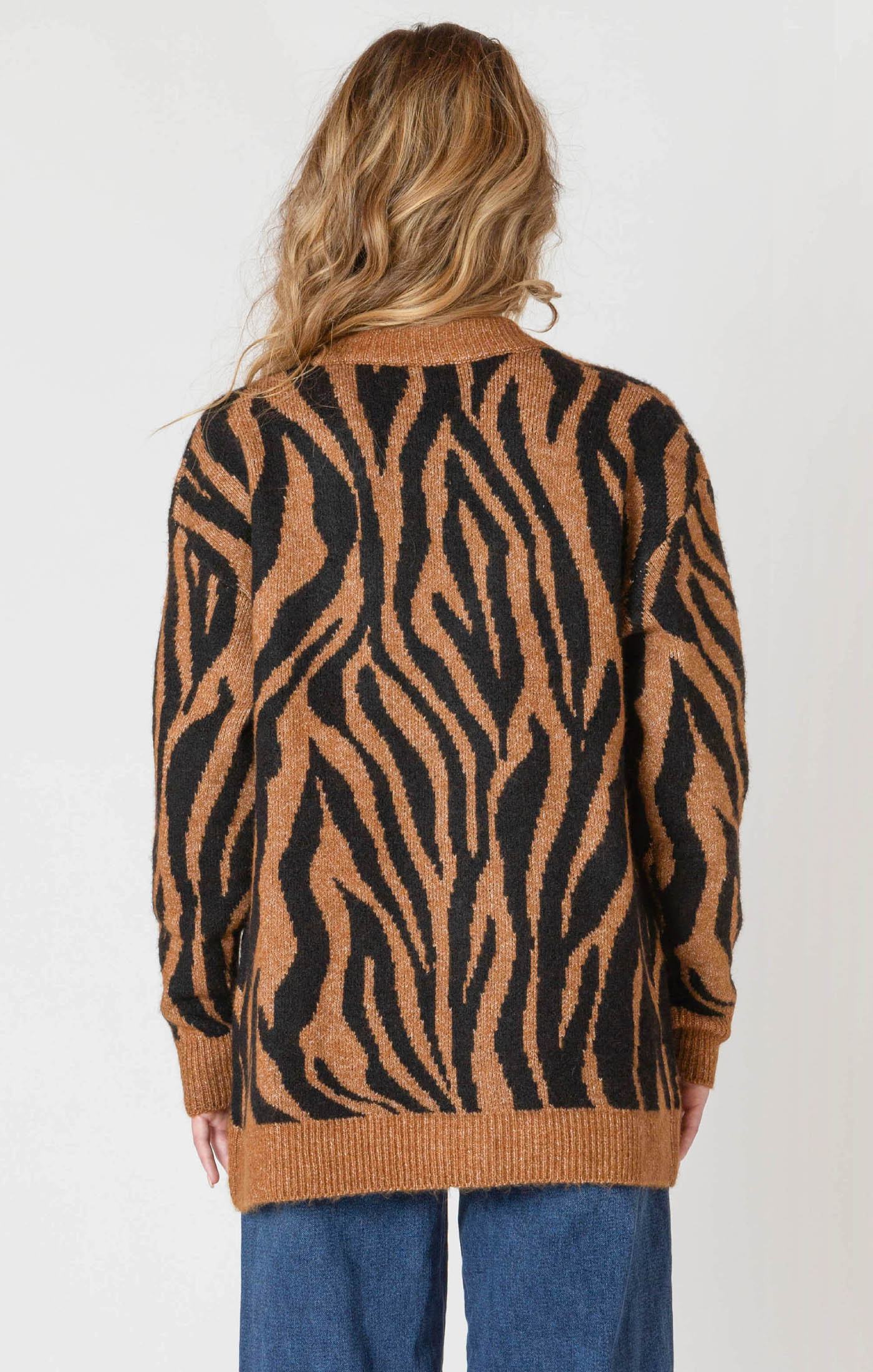 A luxuriously soft brown cardigan, with black animal print striping, pockets, and a button down front.