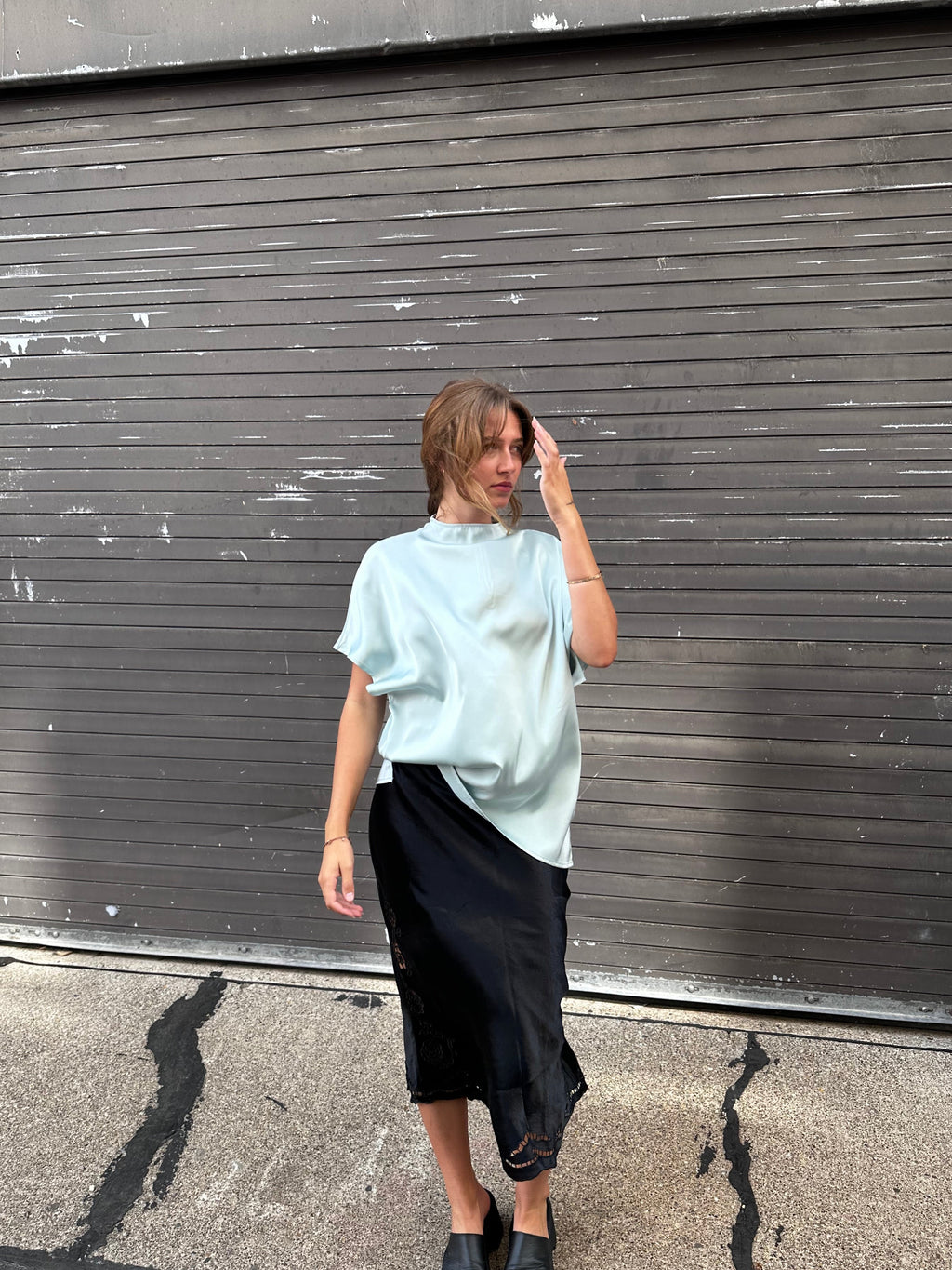 A minty green satin top with a unique neck detail.