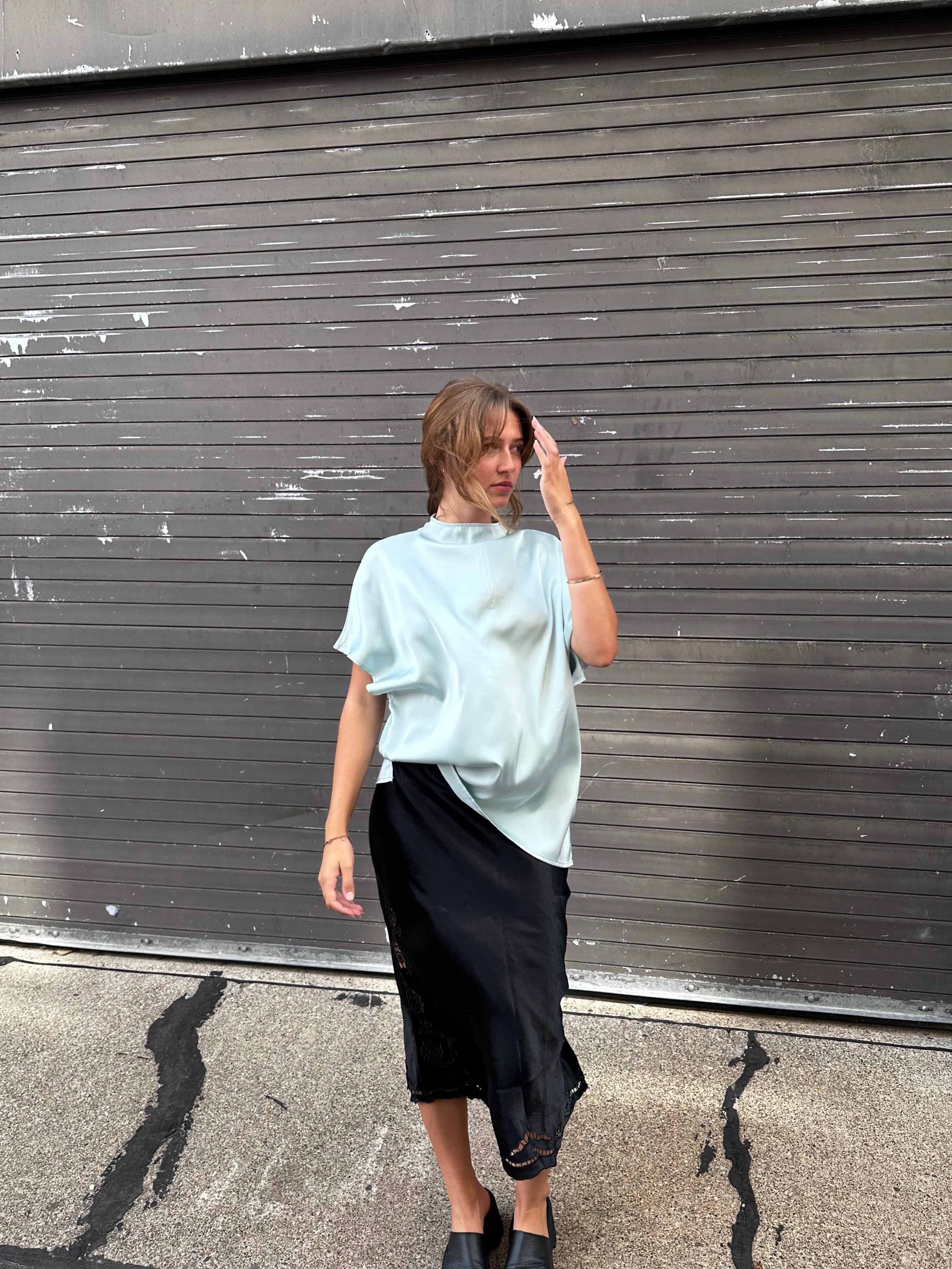 A minty green satin top with a unique neck detail.