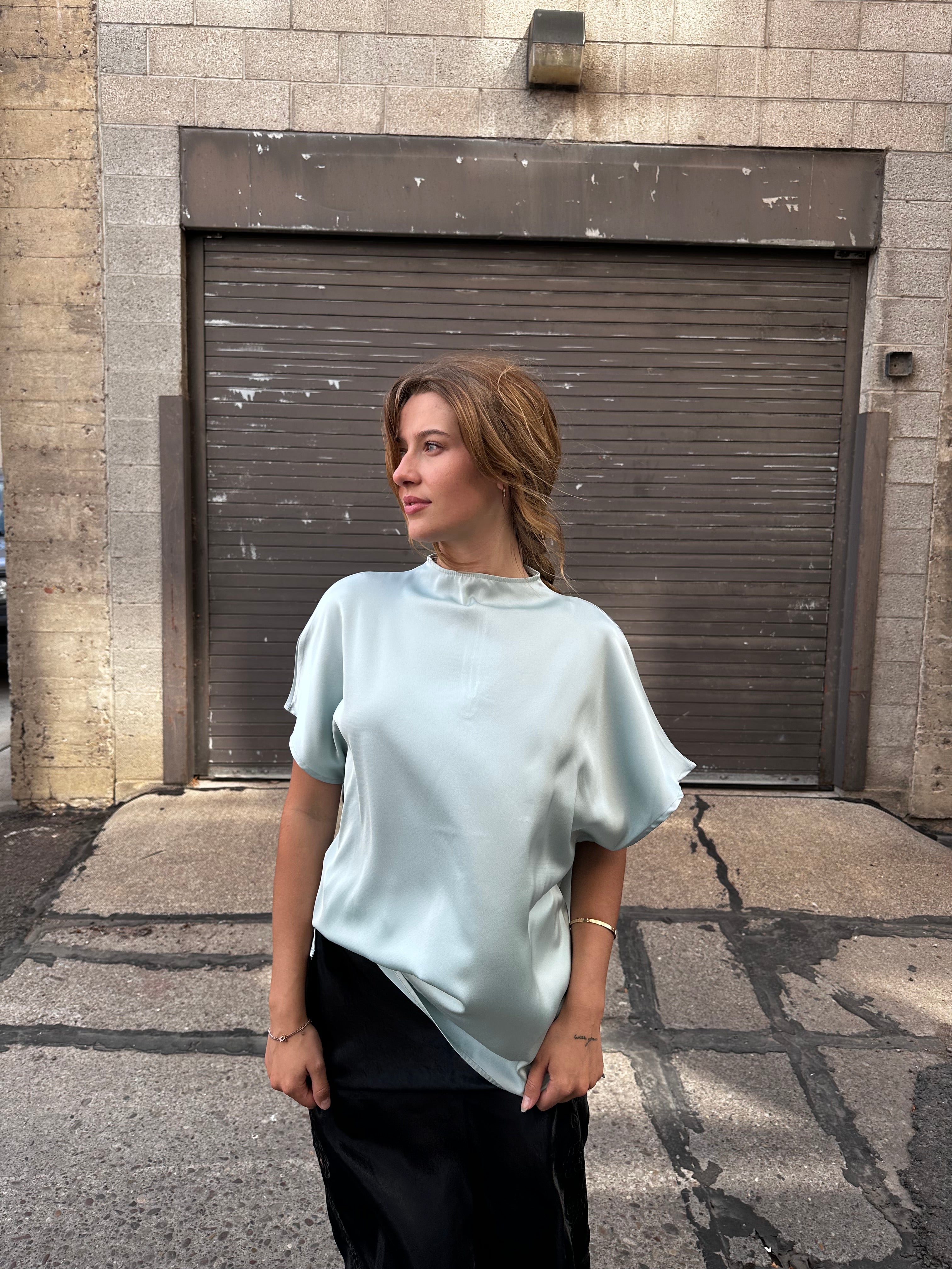 A minty green satin top with a unique neck detail.