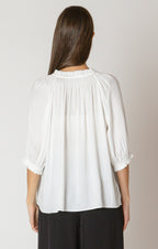 A beautiful white blouse, with a drawstring neck detail, and cinched 3/4 length sleeves.