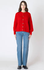 A bright red, chunky knit cardigan, with long tighter wrist sleeves, and button down front.