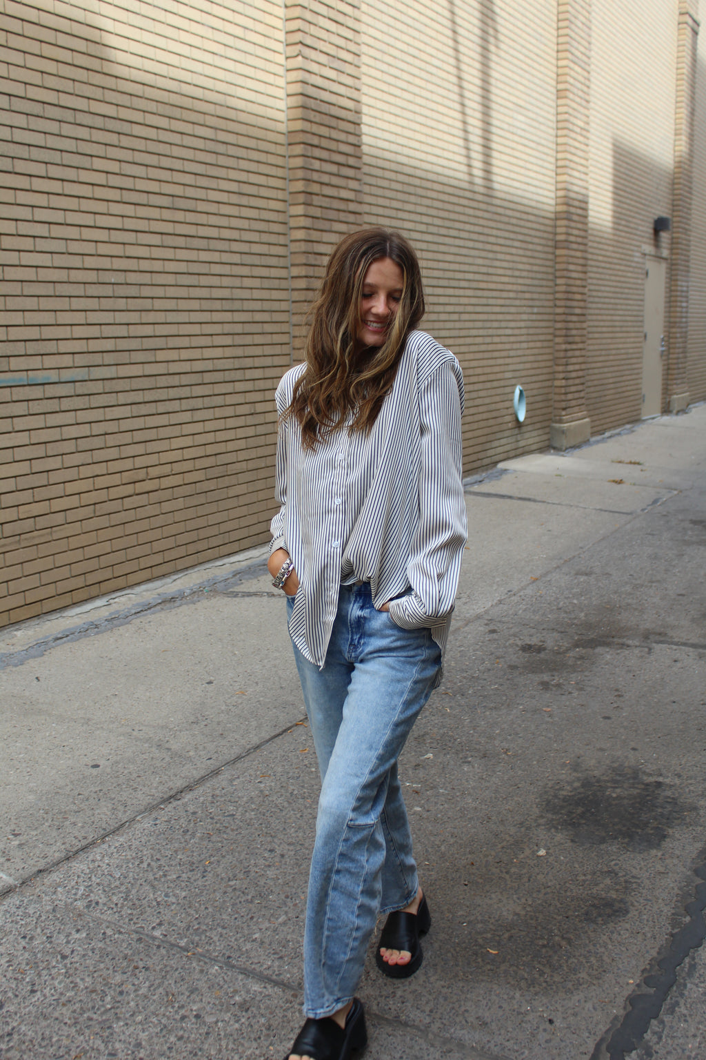Person wearing and black and white vertical striped button down. 