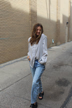 Person wearing and black and white vertical striped button down. 
