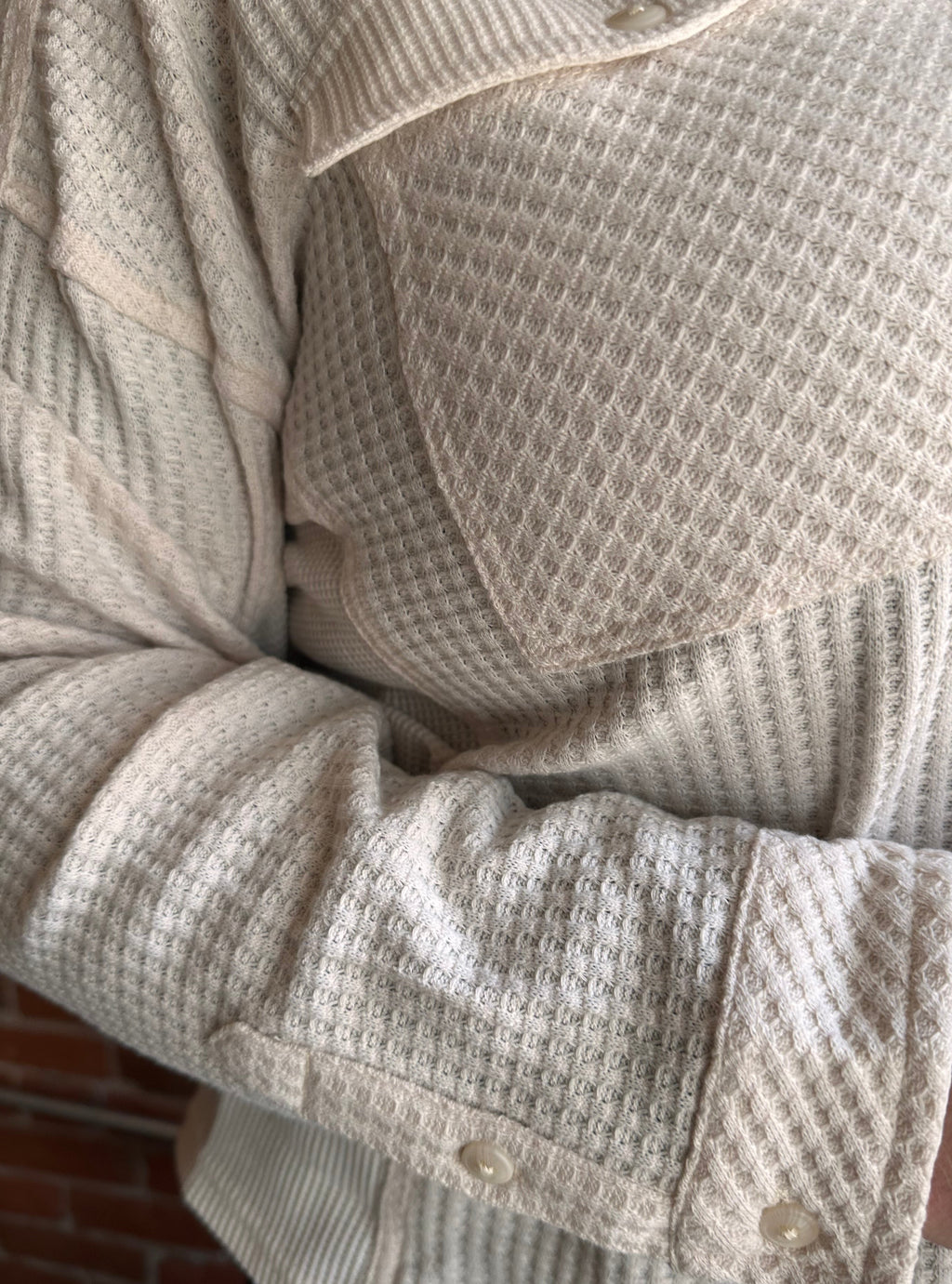 Close-up of textured beige fabric with a focus on texture and pattern.
