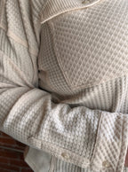 Close-up of textured beige fabric with a focus on texture and pattern.