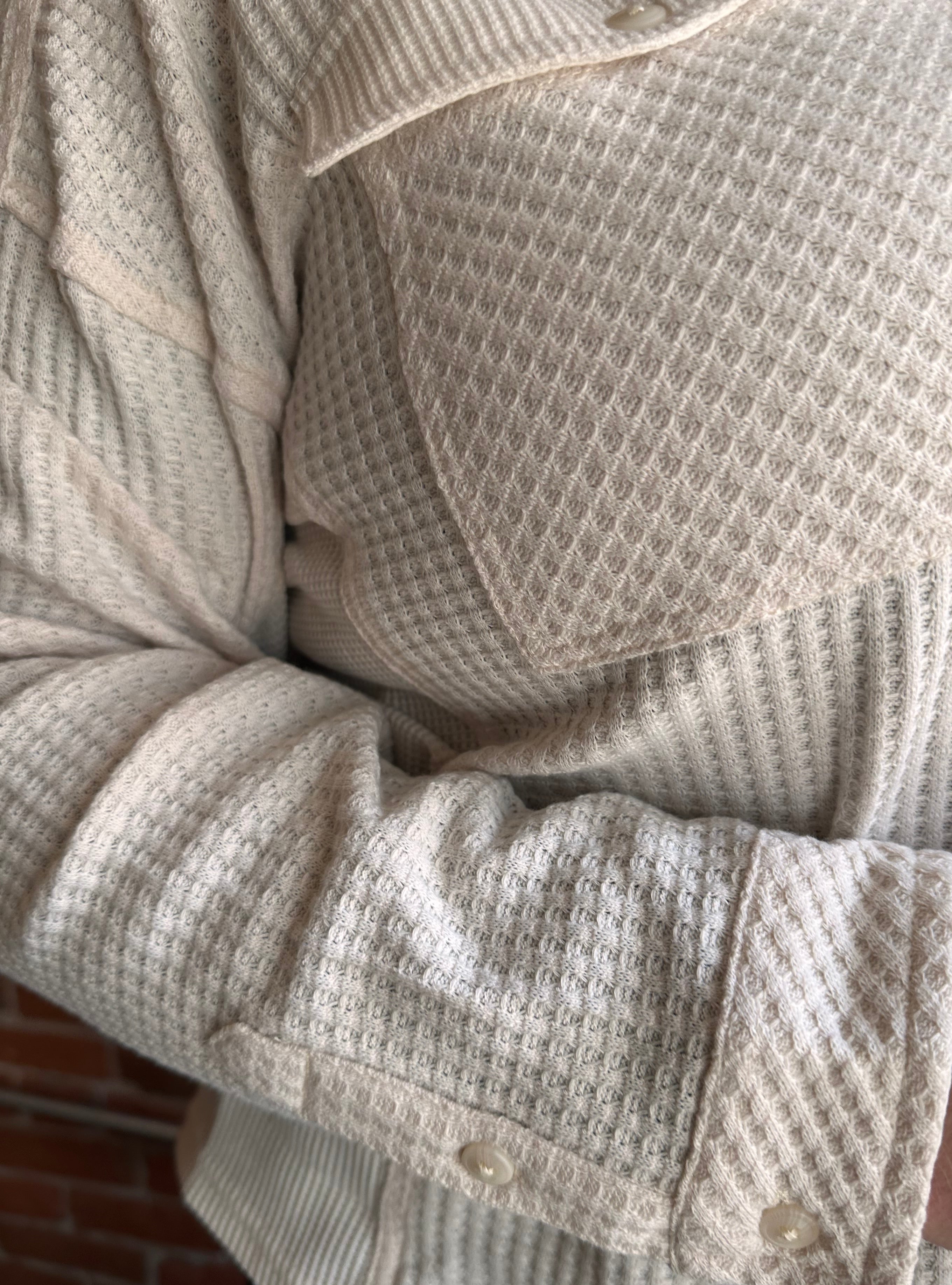 Close-up of textured beige fabric with a focus on texture and pattern.