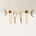 Set of gold earrings with black stone and crystal details.